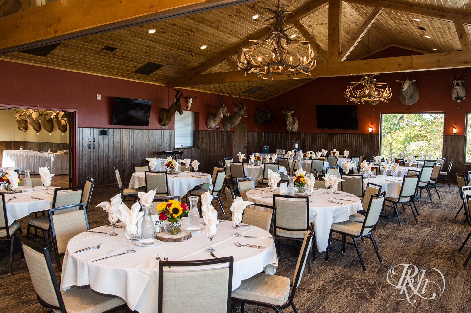 Indoor wedding reception setup with sunflowers at Minnesota Horse and Hunt Club in Prior Lake, Minnesota.