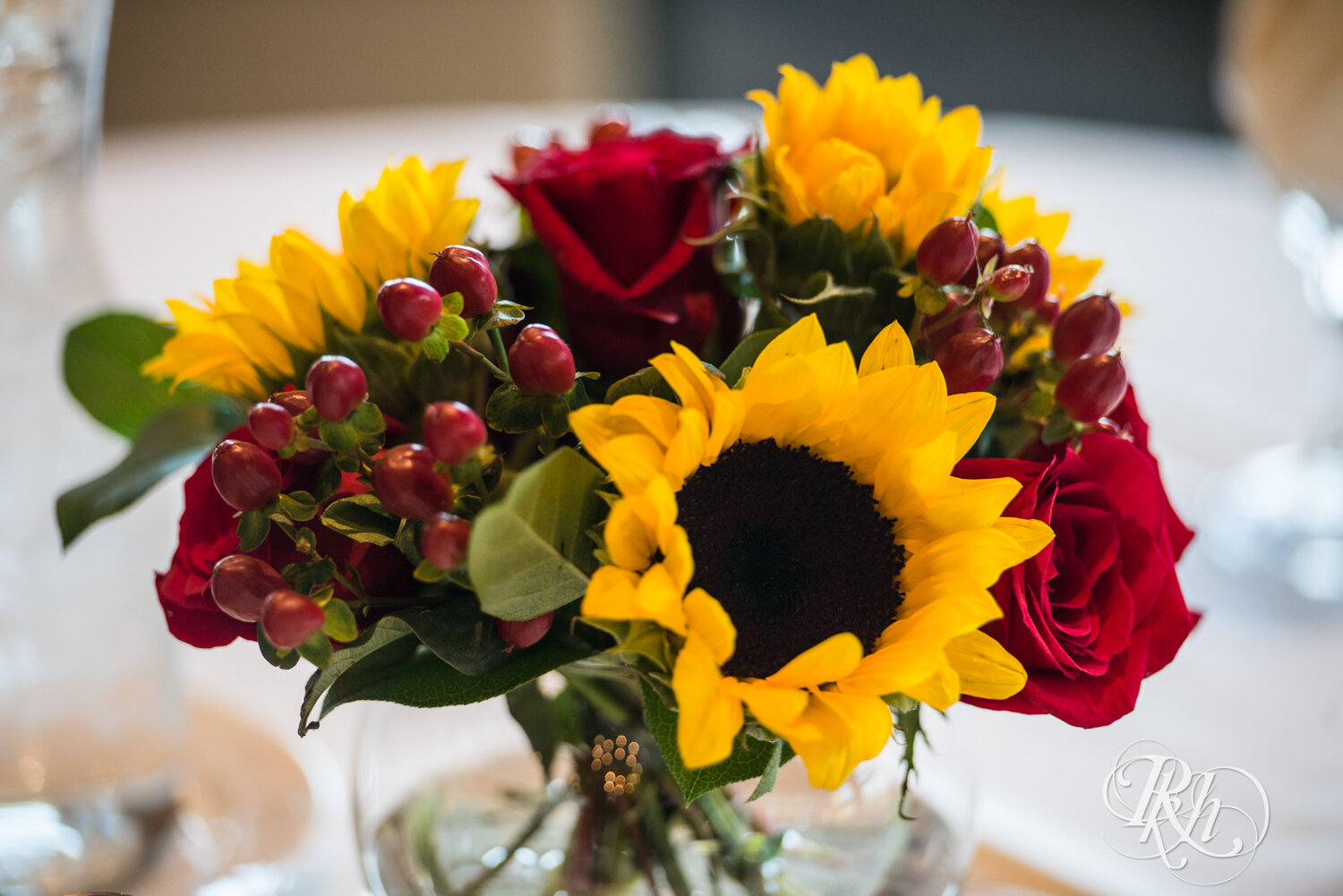 Indoor wedding reception setup with sunflowers at Minnesota Horse and Hunt Club in Prior Lake, Minnesota.