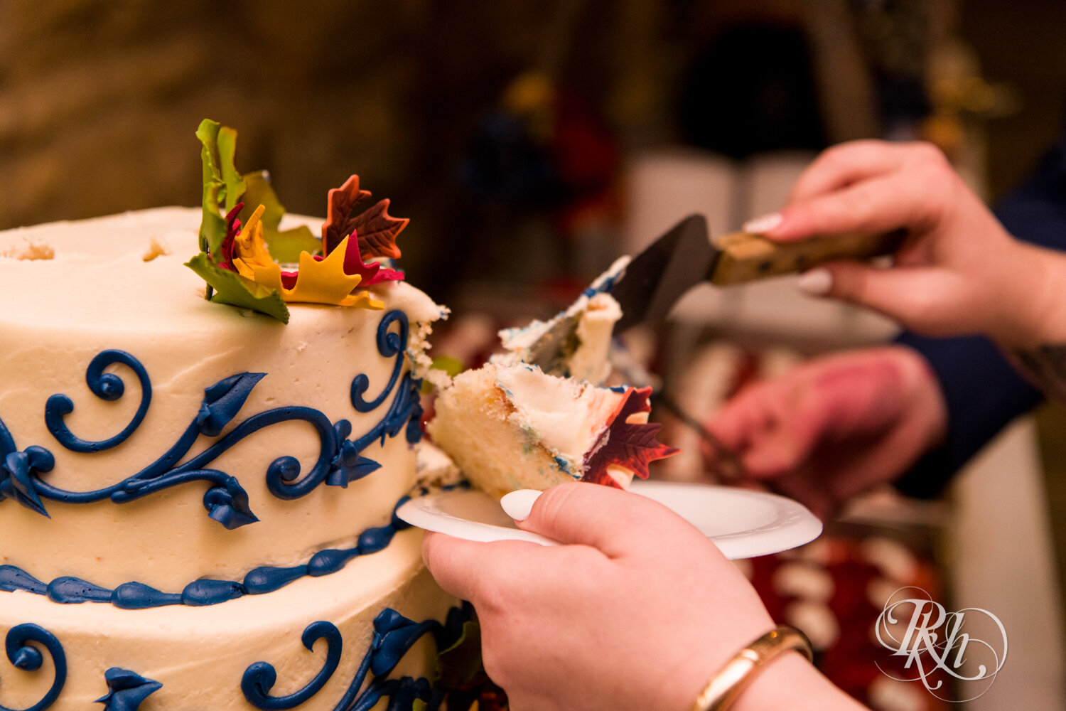 Plus size bride and groom cut cake at wedding reception at Olmsted County Fairgrounds in Rochester, Minnesota.