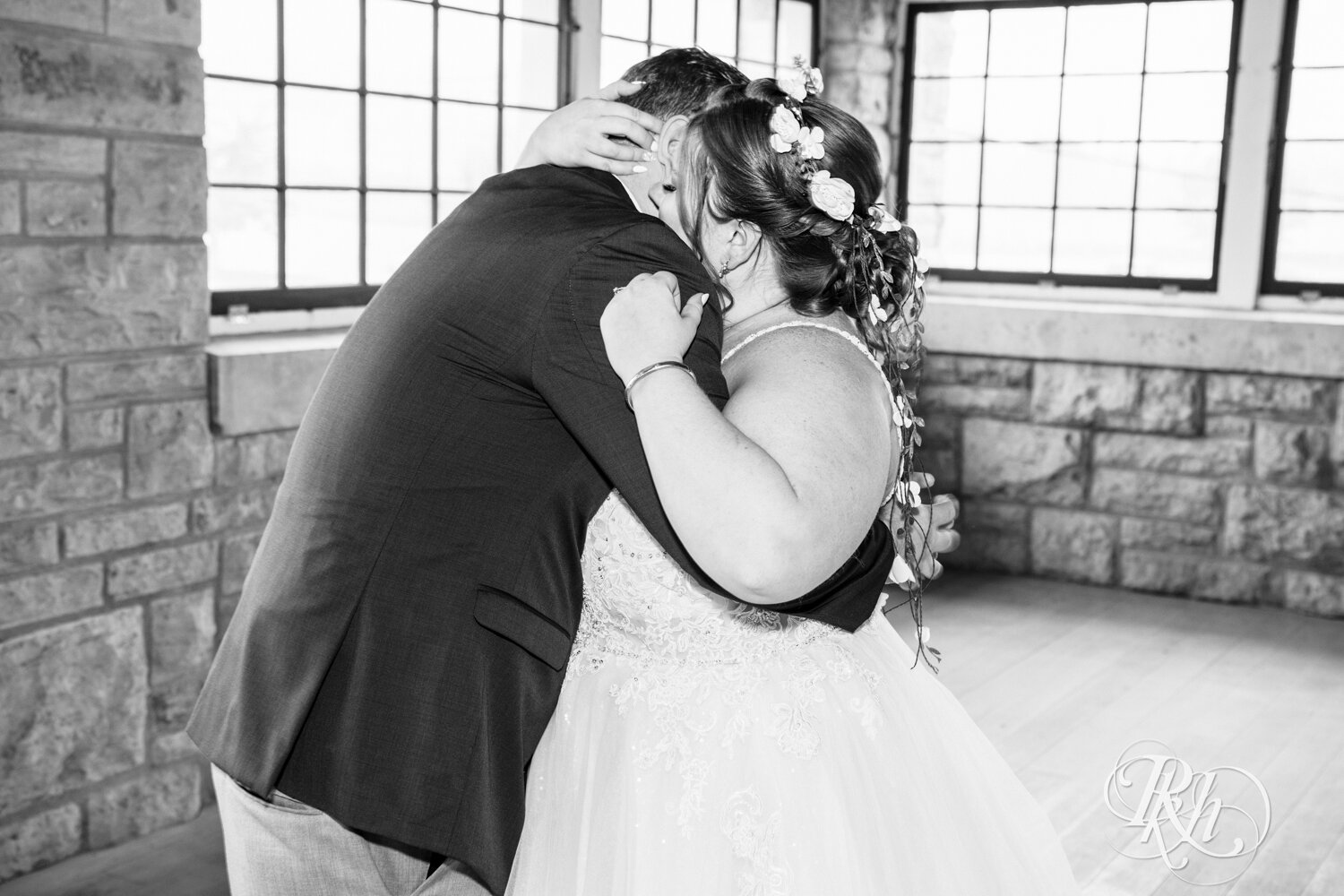 Plus size bride and groom share first look at wedding at Olmsted County Fairgrounds in Rochester, Minnesota.