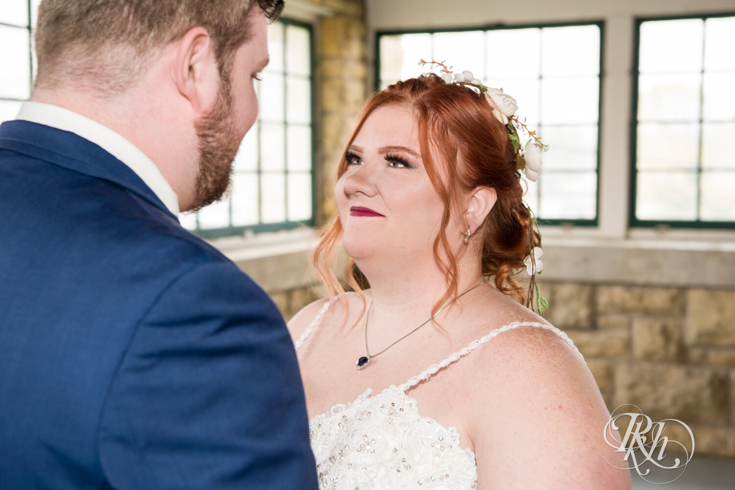 Plus size bride and groom share first look at wedding at Olmsted County Fairgrounds in Rochester, Minnesota.