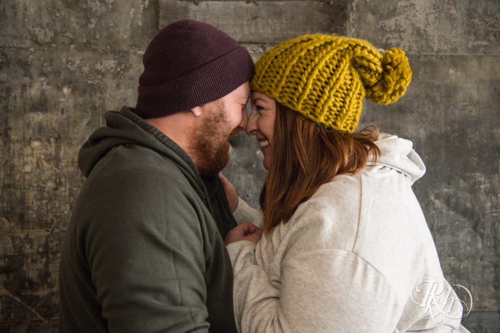 Couple smiling at each other in winter hats