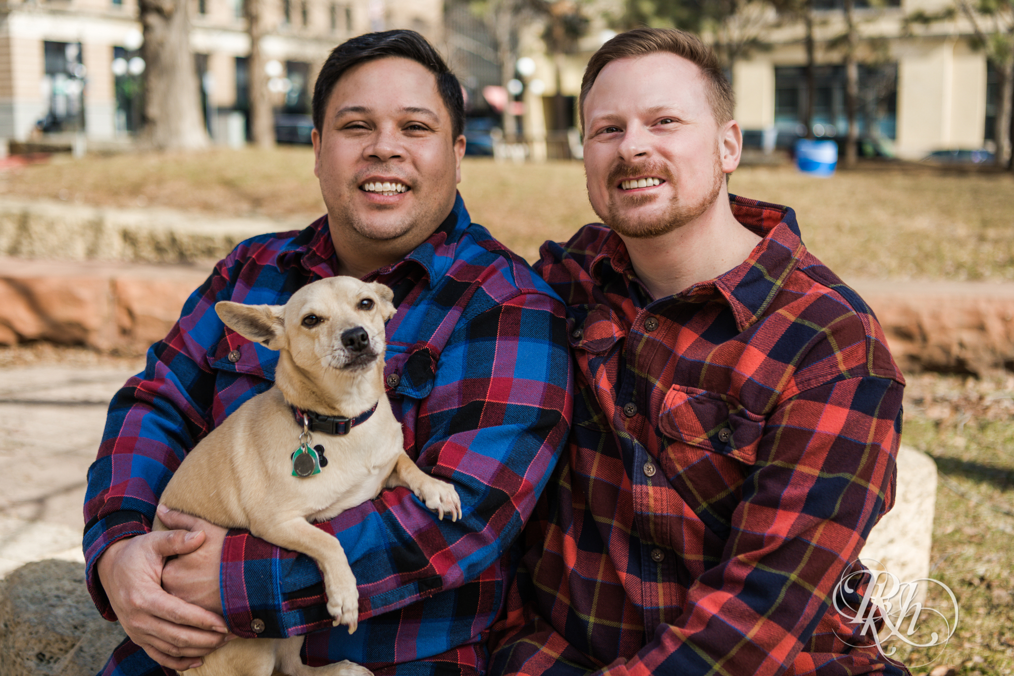 Two gay men in flannels smile while holding a Chihuahua in Saint Paul, Minnesota.