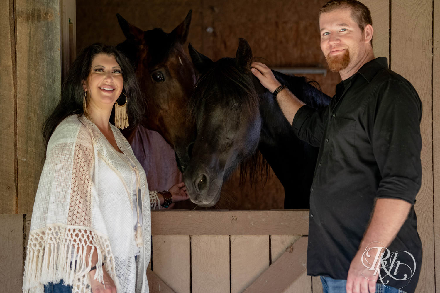 Lebanese woman and man smile at their horse farm in Chisago City, Minnesota.