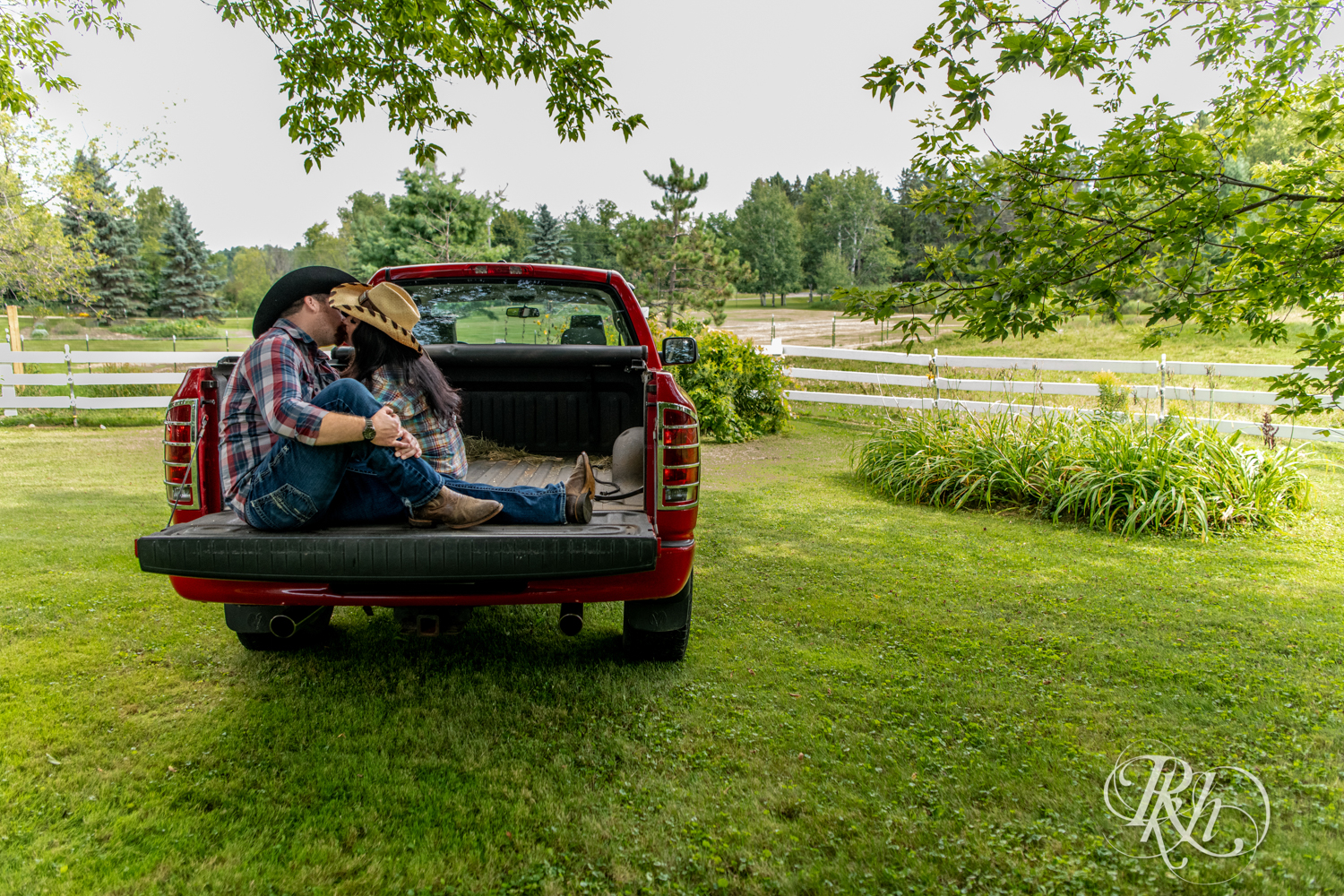 Lebanese woman and man kiss in their pickup truck at their horse farm in Chisago City, Minnesota.