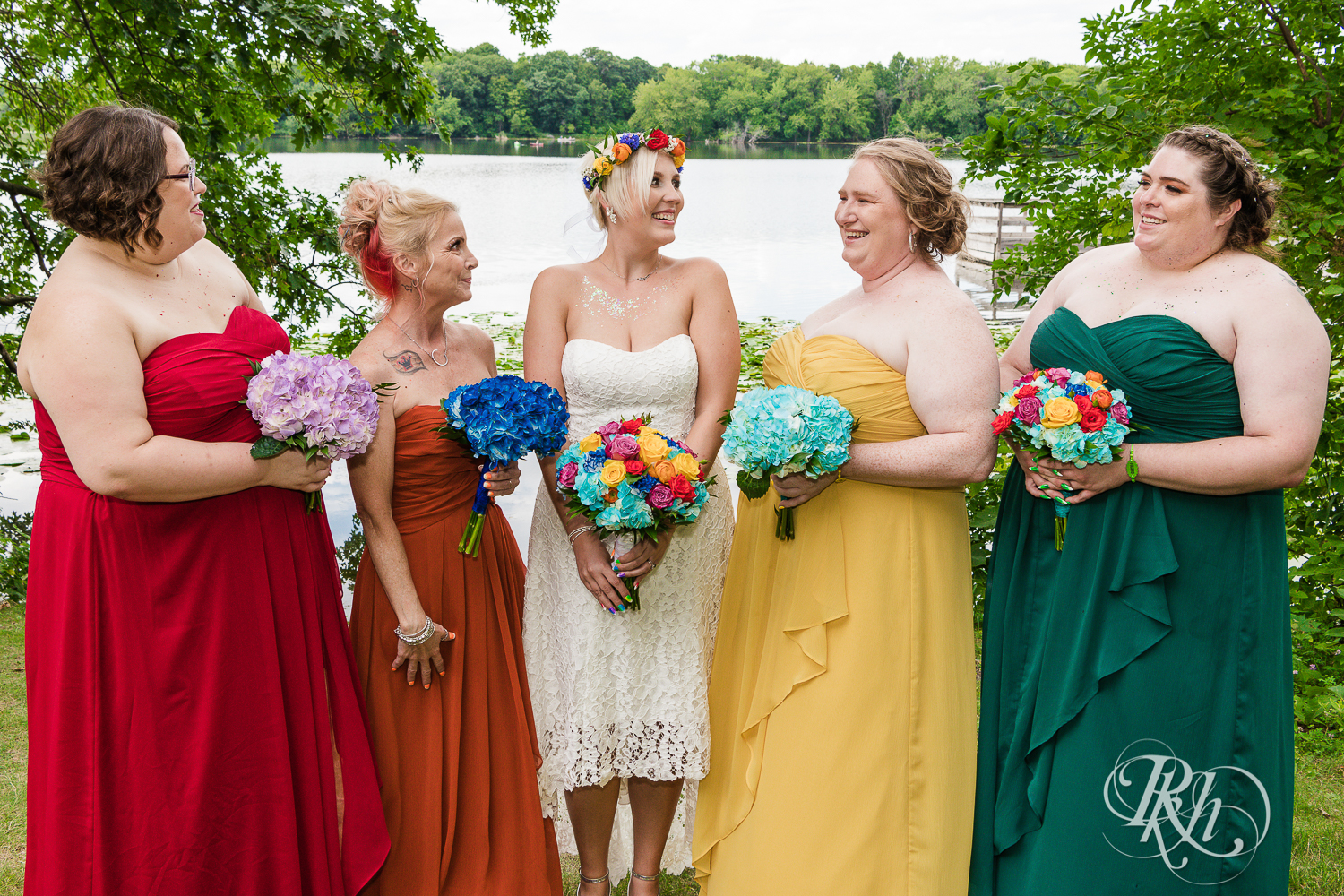 Wedding party with rainbow color scheme on dock in Cleary Lake, Minnesota.