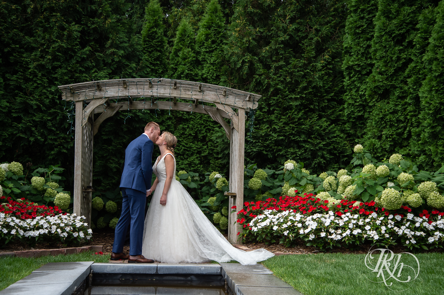Bride and groom kiss at wedding ceremony at the William Sauntry Mansion in Stillwater, Minnesota.