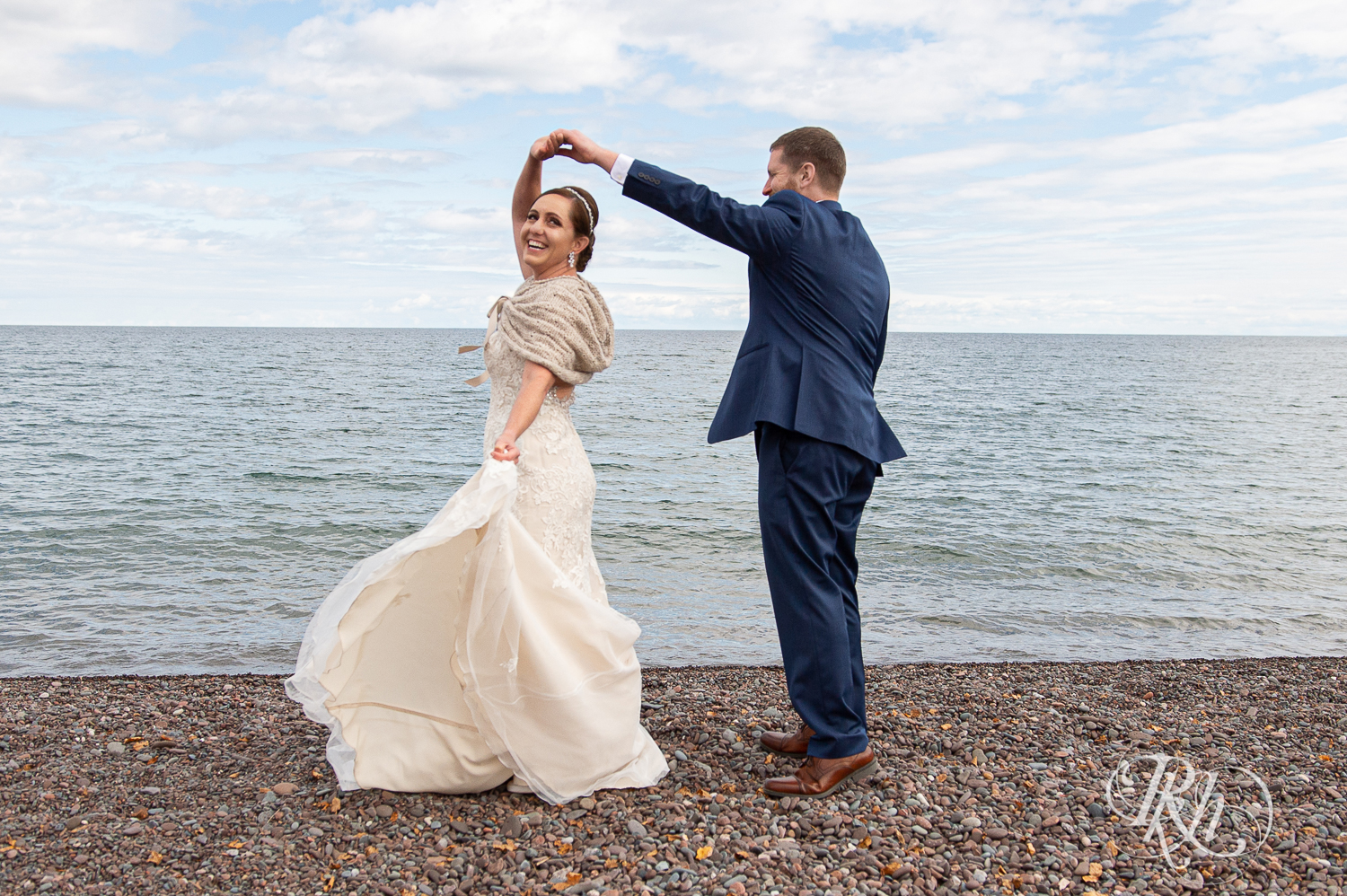 Bride and groom dance on beach of Lake Superior at Superior Shores Resort in Two Harbors, Minnesota.