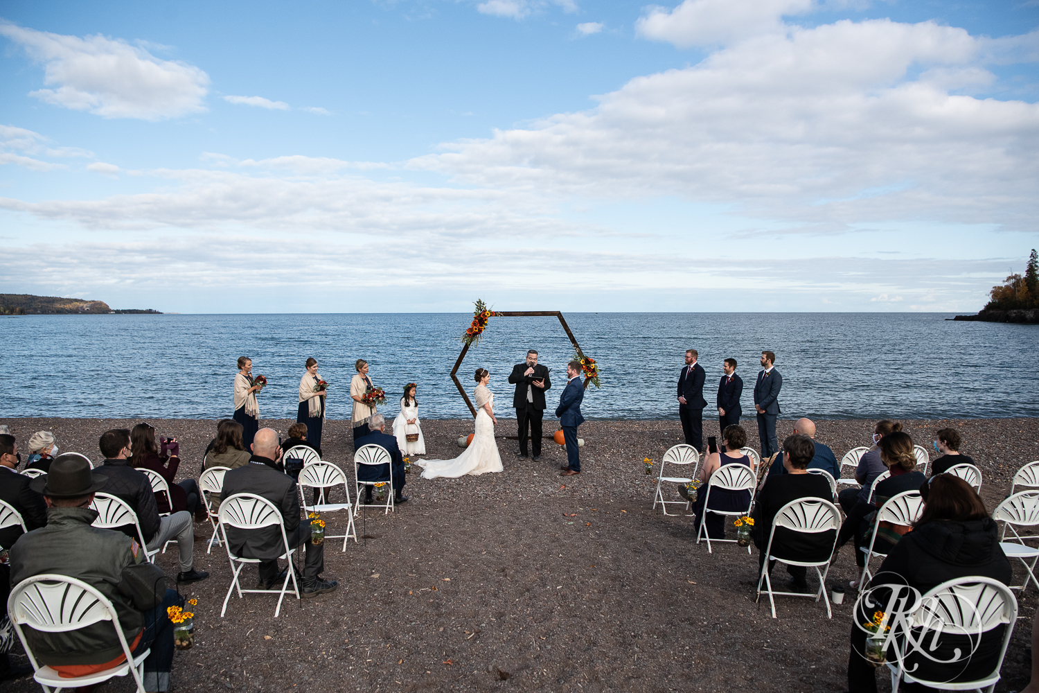 Wide photo of wedding ceremony in front of Lake Superior at Superior Shores Resort in Two Harbors, Minnesota.