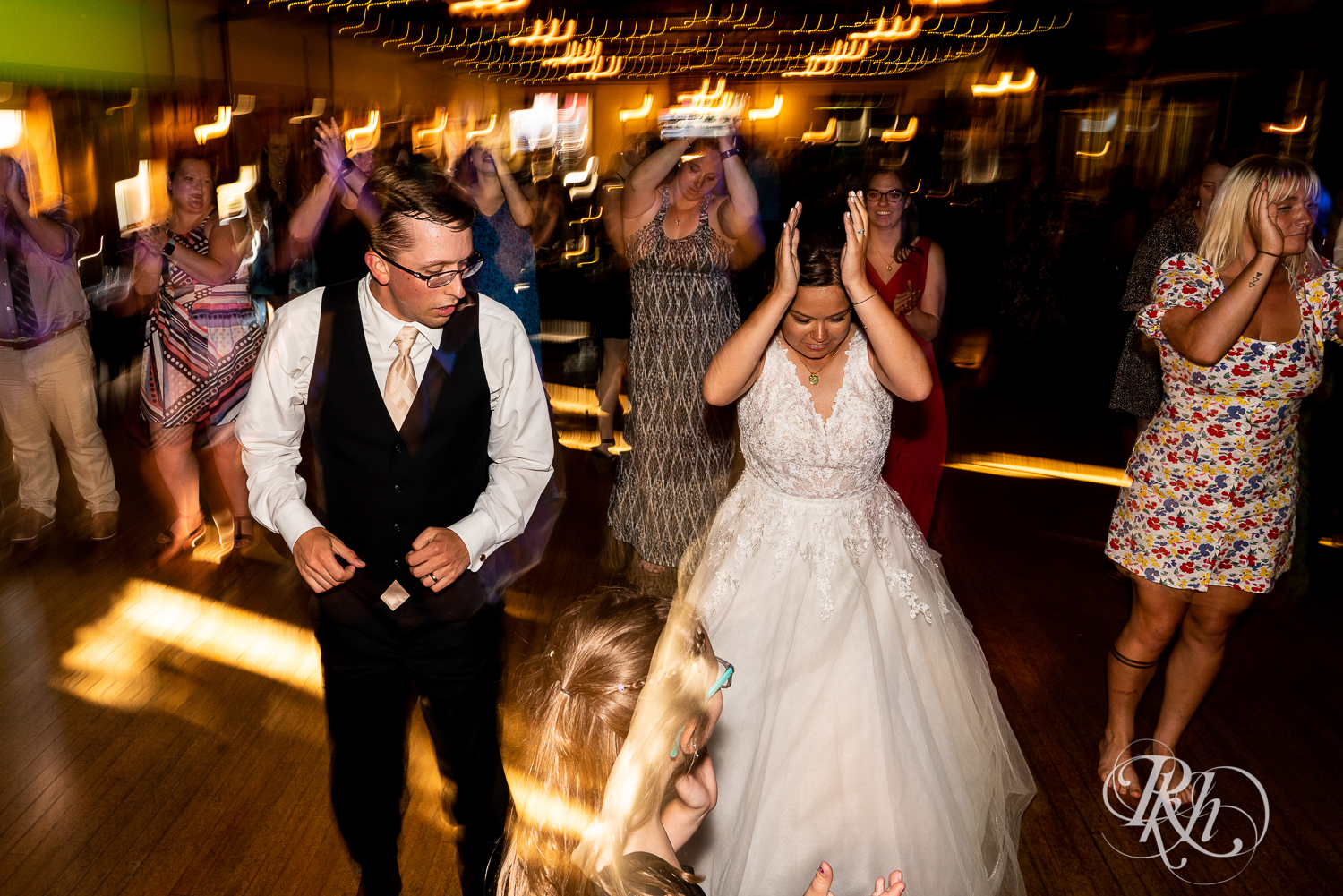 Guests dance with bride and groom at wedding reception at Kellerman's Event Center in White Bear Lake, Minnesota.