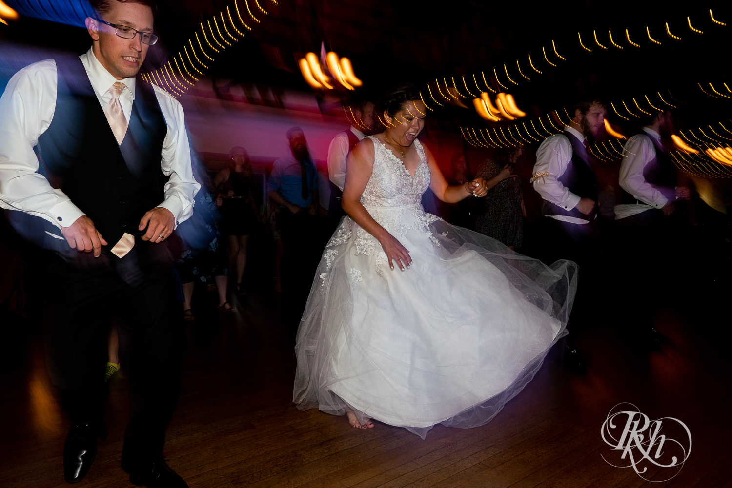 Guests dance with bride and groom at wedding reception at Kellerman's Event Center in White Bear Lake, Minnesota.
