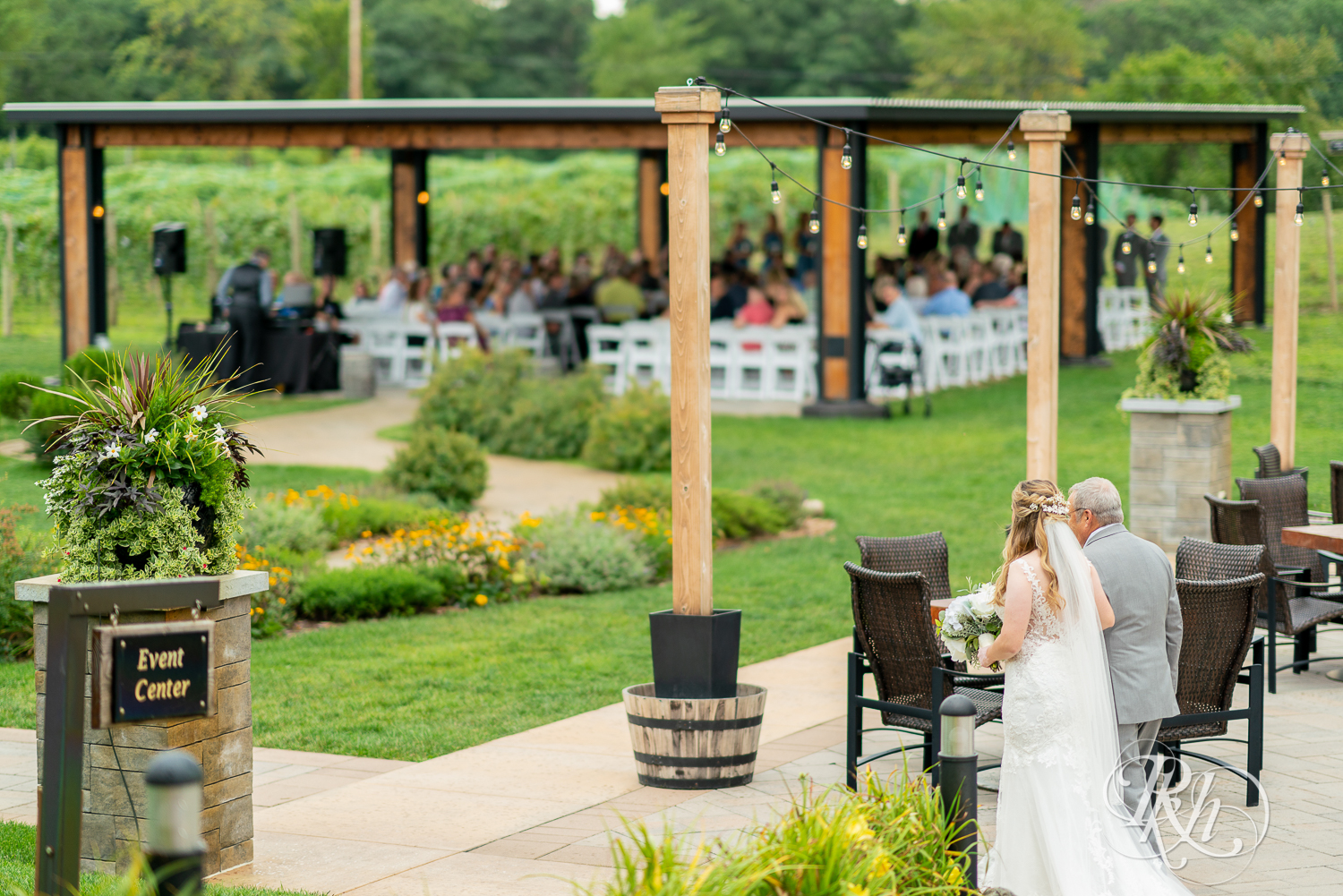 Bride walking down the aisle with her dad at 7 Vines Vineyard in Dellwood, Minnesota.