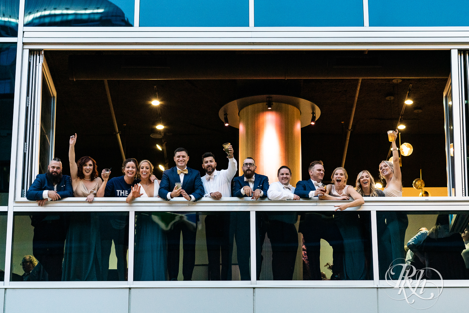 Wedding party cheers out the window of the Saint Paul Event Center in Saint Paul, Minnesota.