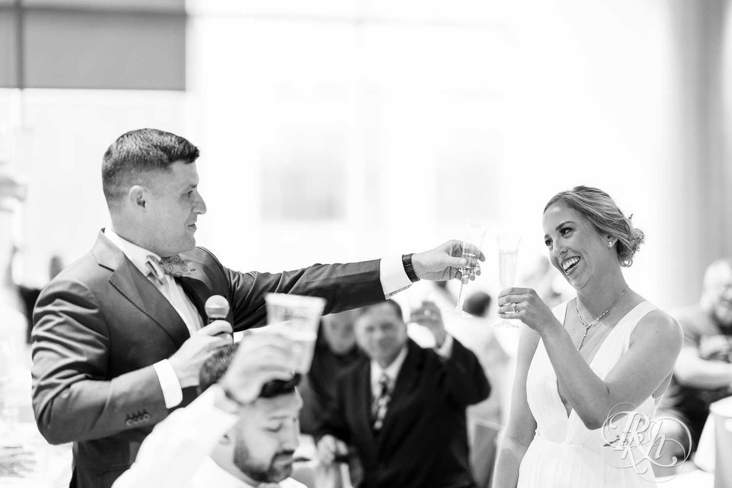 Bride and groom toast during wedding reception at Saint Paul Event Center in Saint Paul, Minnesota.