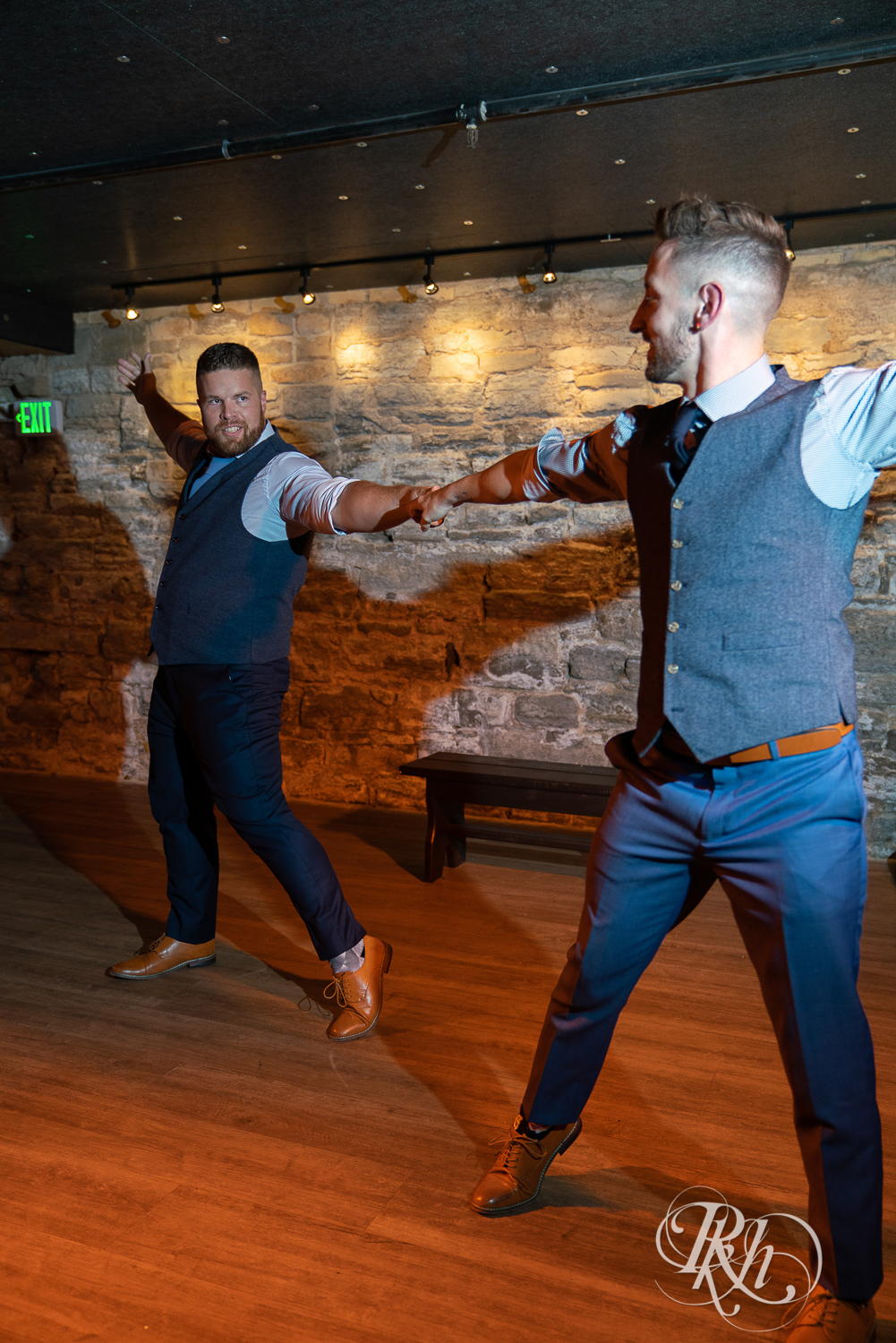 Gay grooms share first dance on wedding day at Hall of Kings in Minneapolis, Minnesota.