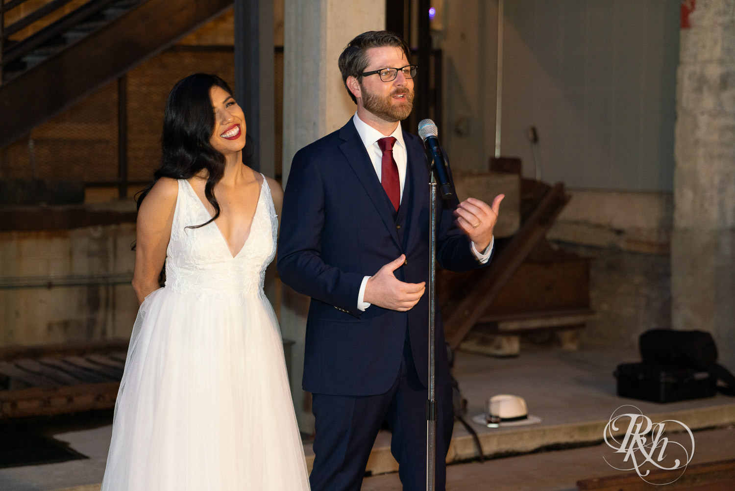 Bride and groom giving thank you speech at wedding reception in Mill City Museum in Minneapolis, Minnesota.