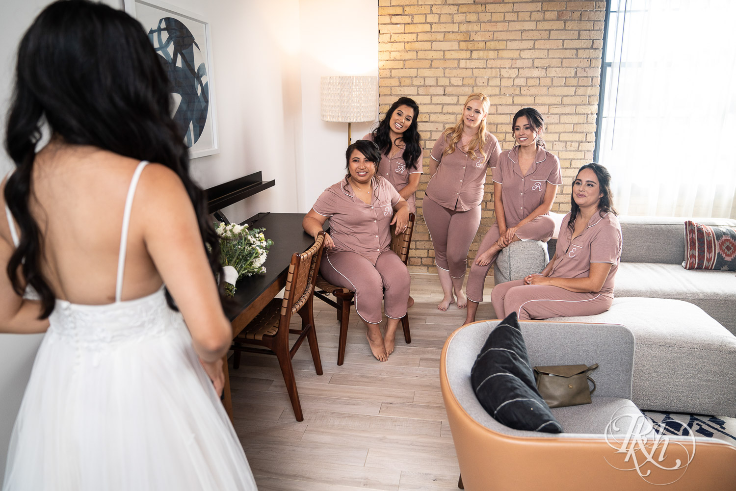 Bride doing first look with her bridesmaids at Hilton Canopy in Minneapolis, Minnesota.