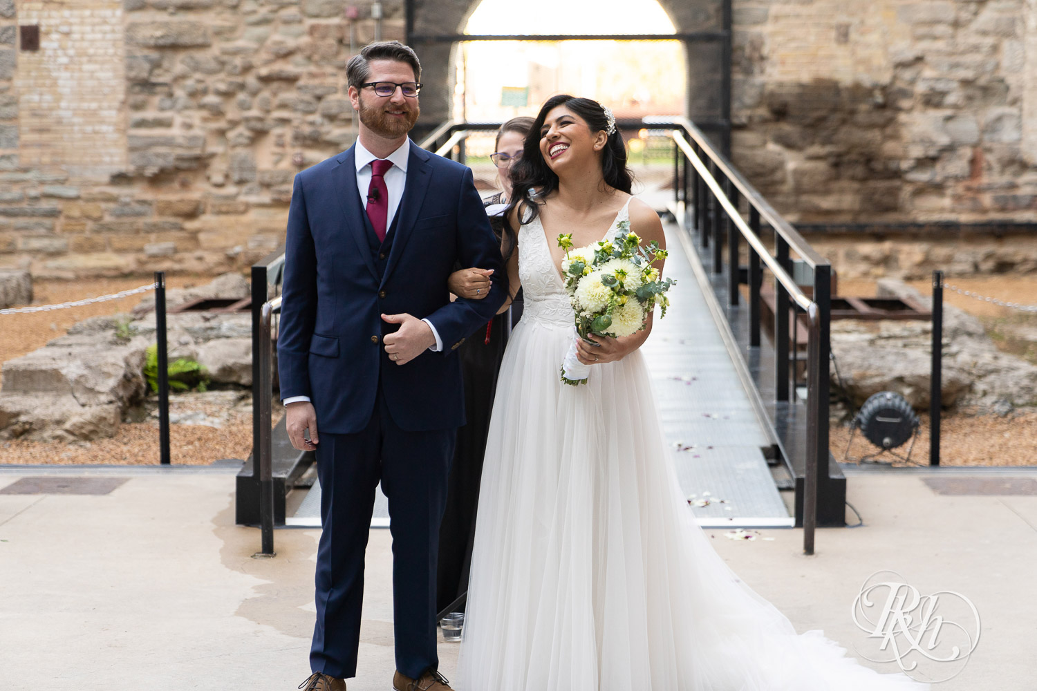Bride and groom walking down alter after wedding ceremony at Mill City Museum in Minneapolis, Minnesota