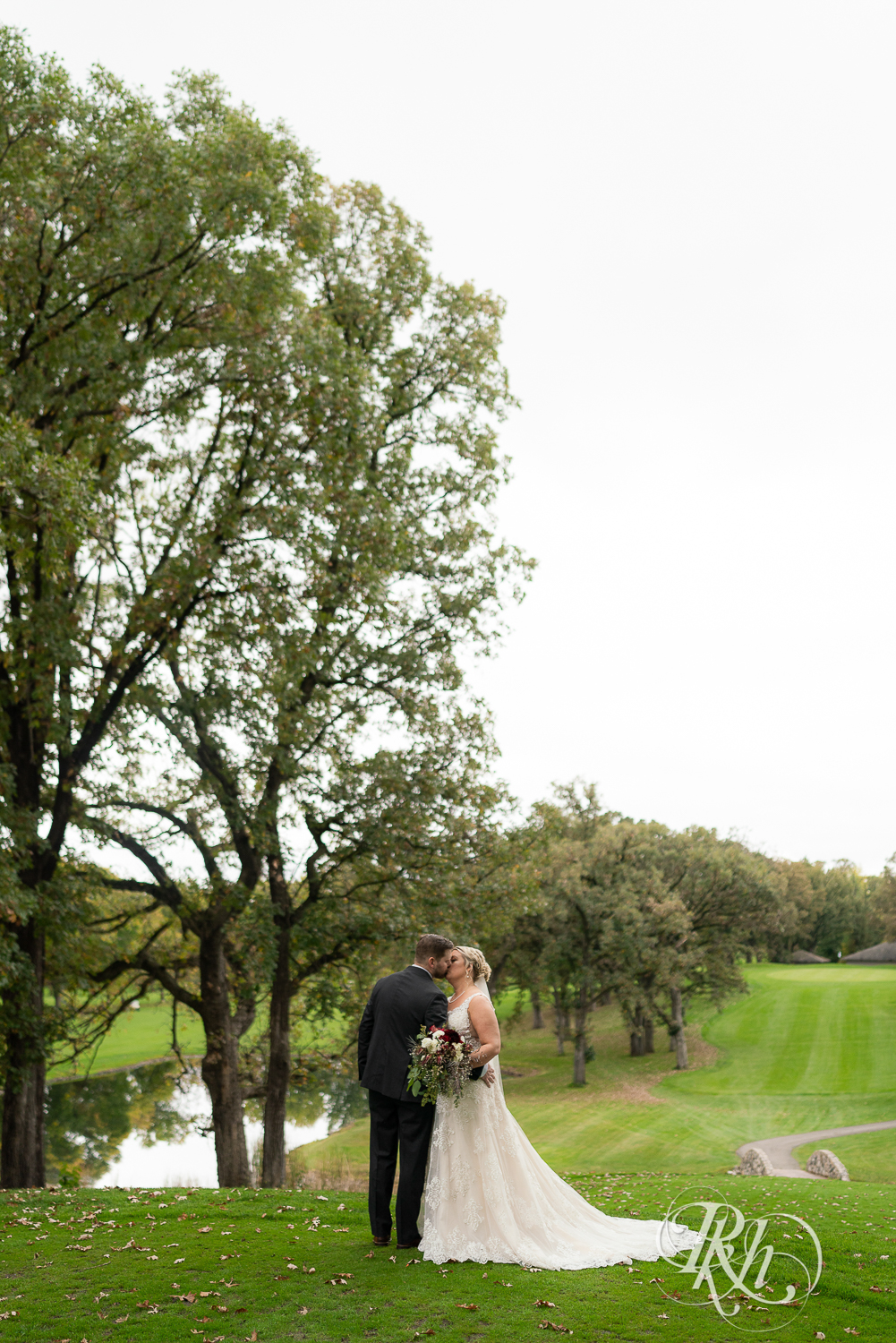 Bride and groom kiss at Hastings Golf Club in Hastings, Minnesota.