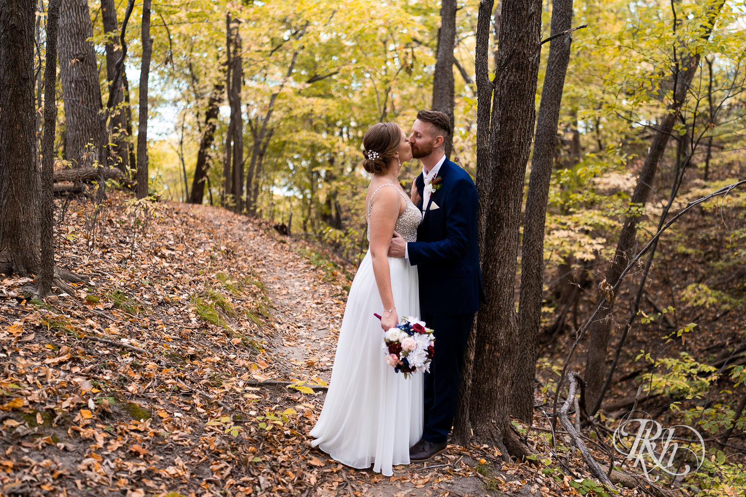 Bride and groom kissing in the woods at Schaar's Bluff in Hastings, Minnesota. 