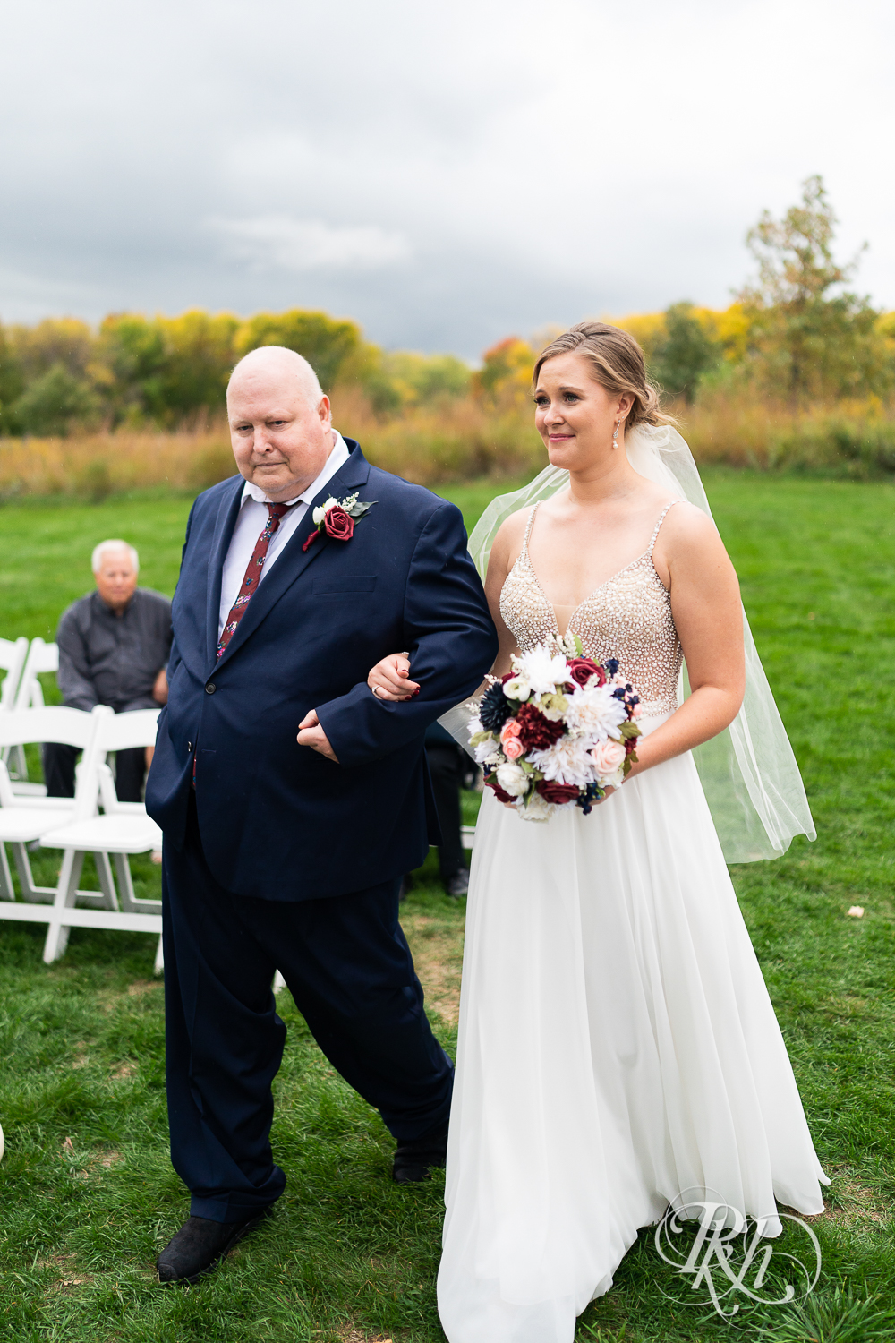 Bride walking down the aisle with father at Schaar's Bluff in Hastings, Minnesota. 