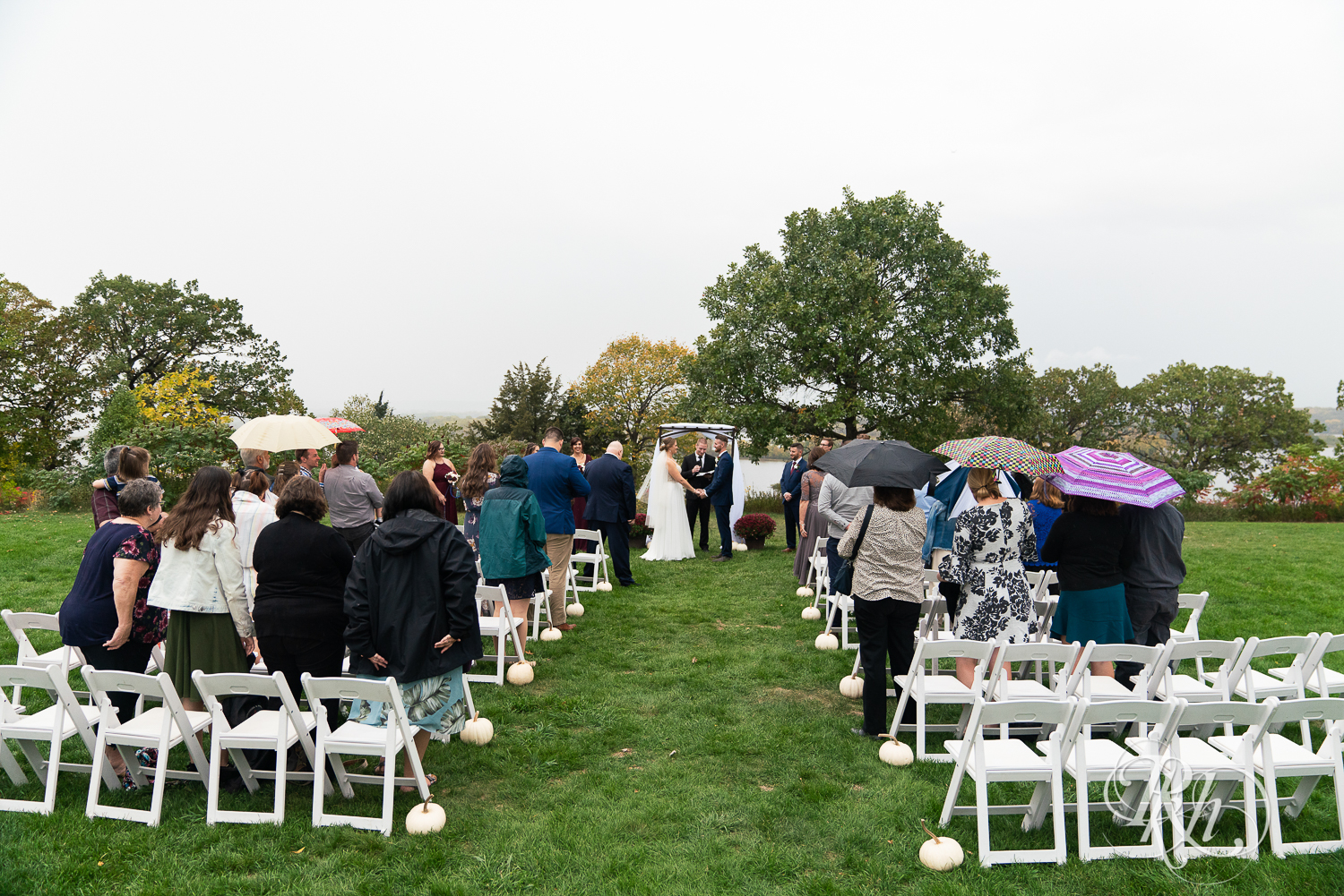 Bride and groom standing at alter at rainy wedding ceremony at Schaar's Bluff in Hastings, Minnesota. 