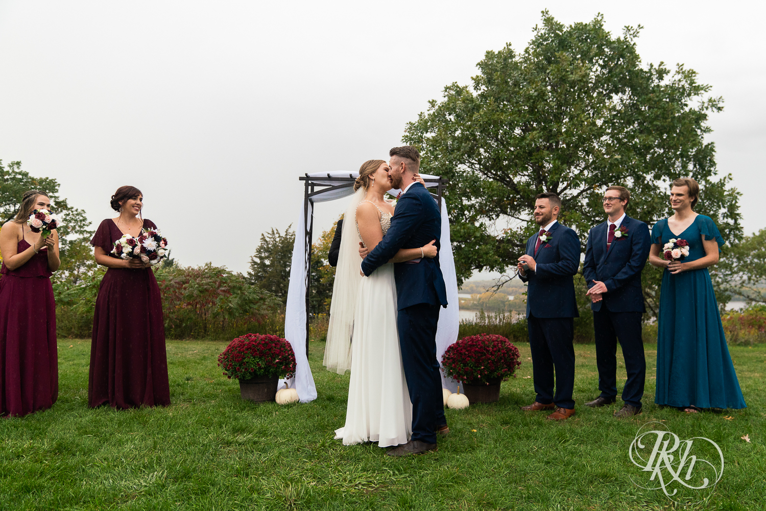 Bride and groom standing at alter at rainy wedding ceremony at Schaar's Bluff in Hastings, Minnesota. 