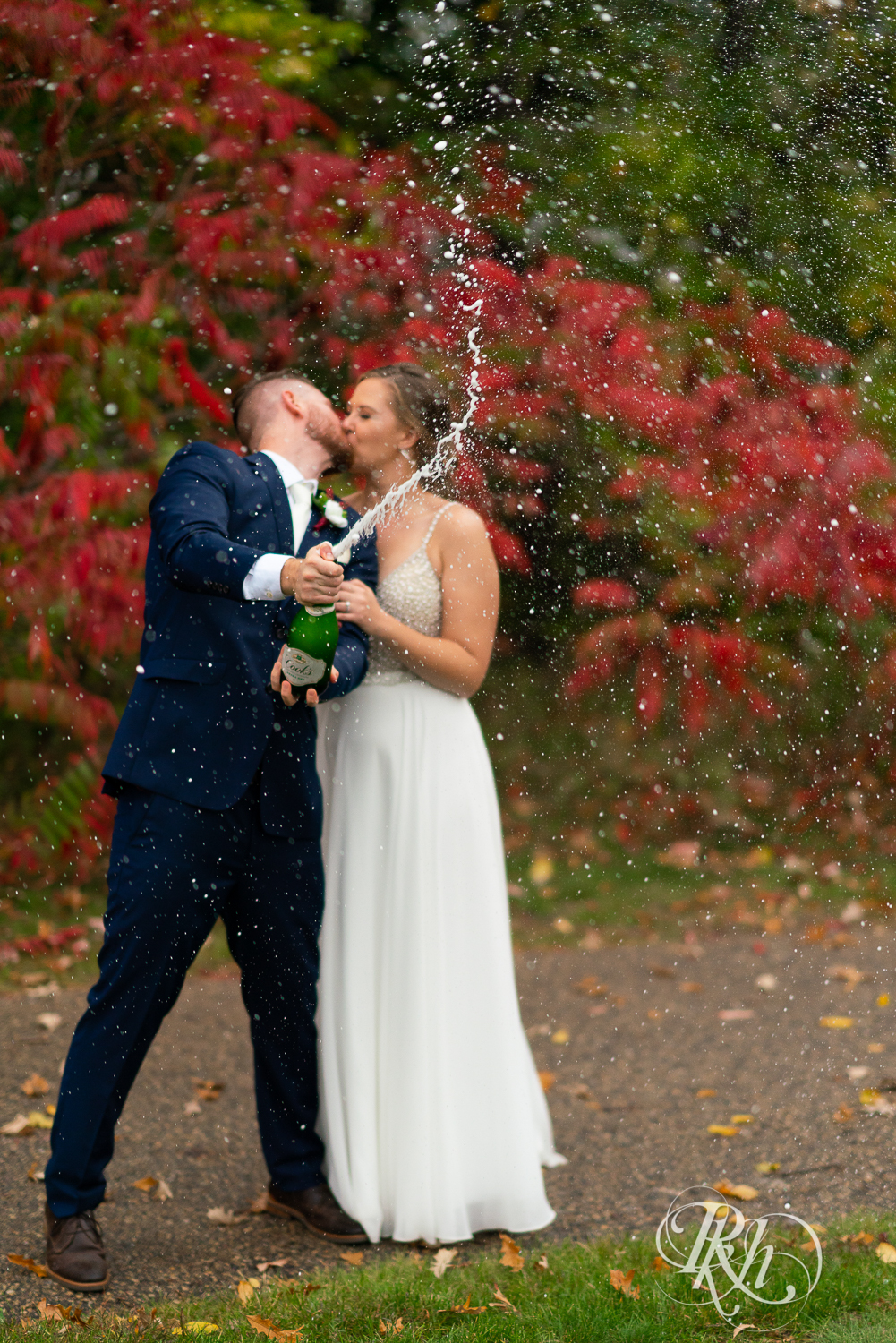 Bride and groom spraying champagne at Schaar's Bluff in Hastings, Minnesota. 