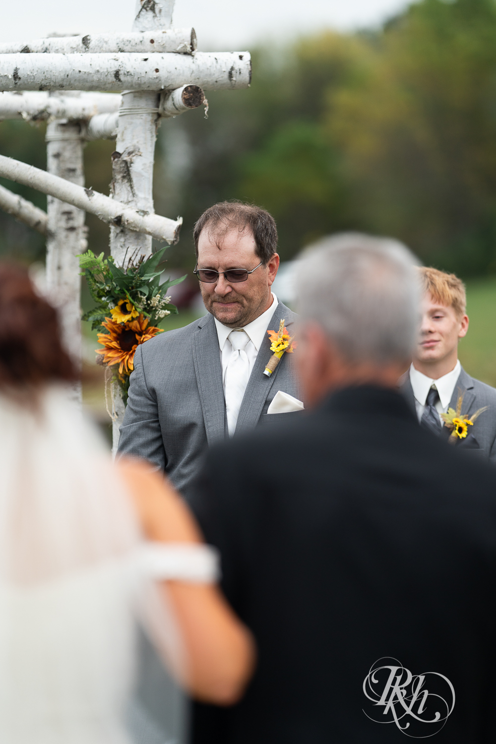 Groom tearing up as bride is walking down the aisle at Barn at Crocker's Creek in Faribault, Minnesota.