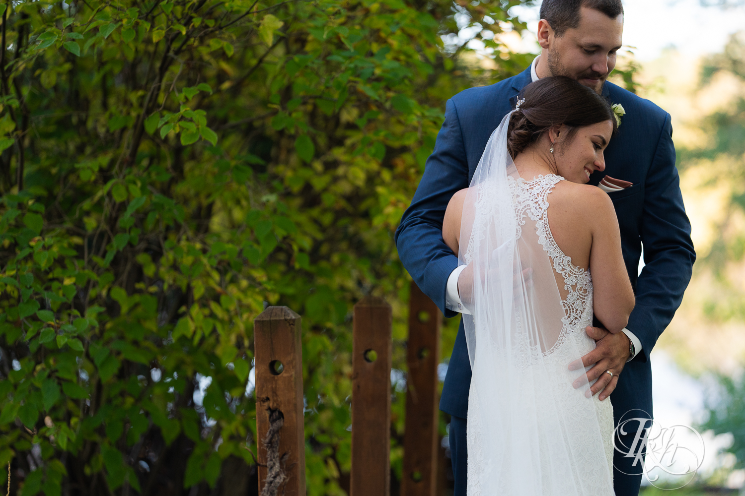 Bride and groom kissing on the bridge at The Chart House in Lakeville, Minnesota.