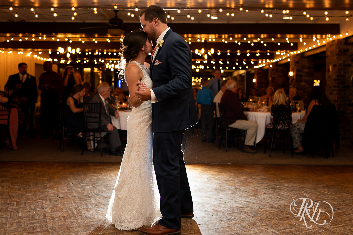 Bride and groom share first dance during wedding reception at The Chart House in Lakeville, Minnesota.