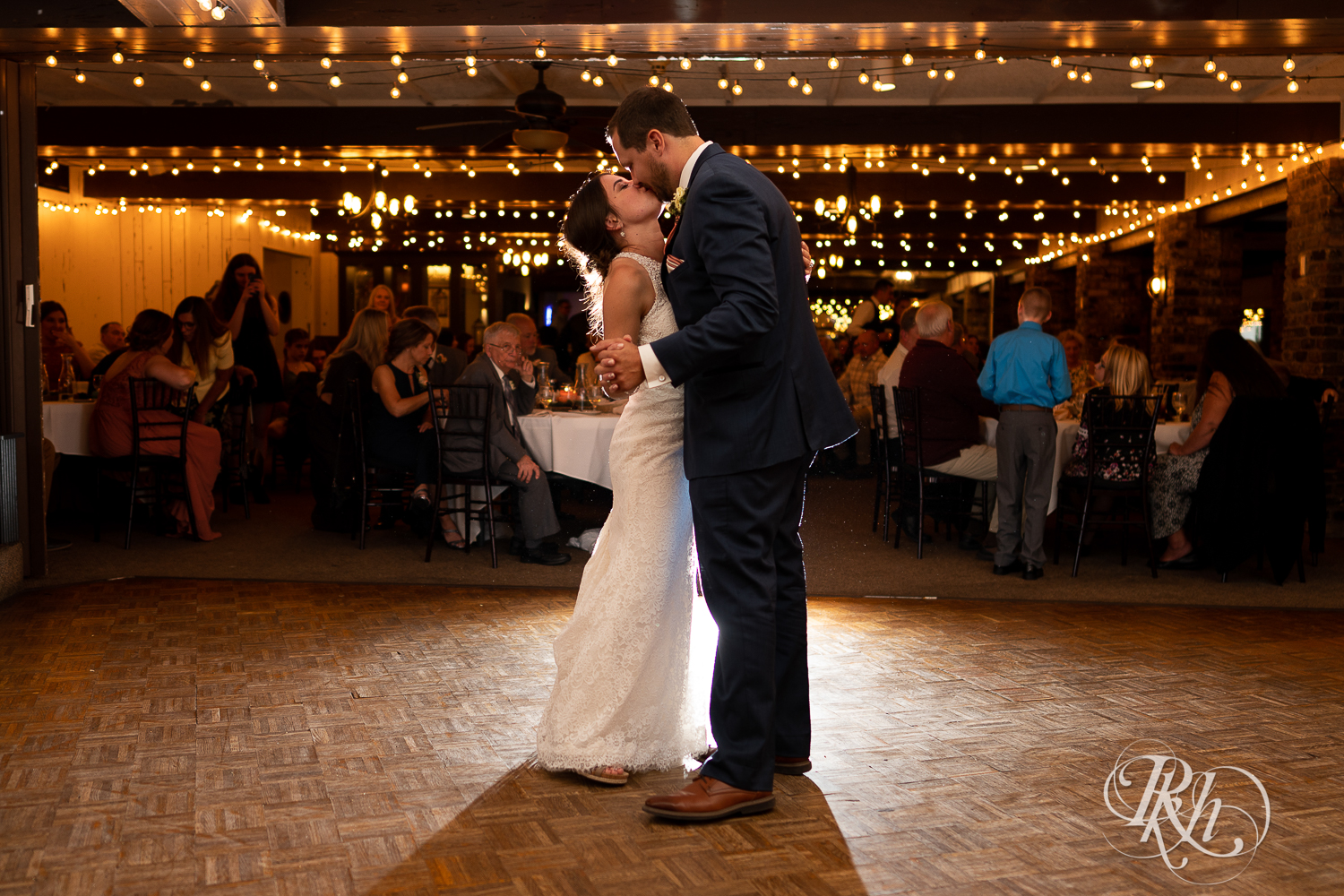 Bride and groom share first dance during wedding reception at The Chart House in Lakeville, Minnesota.