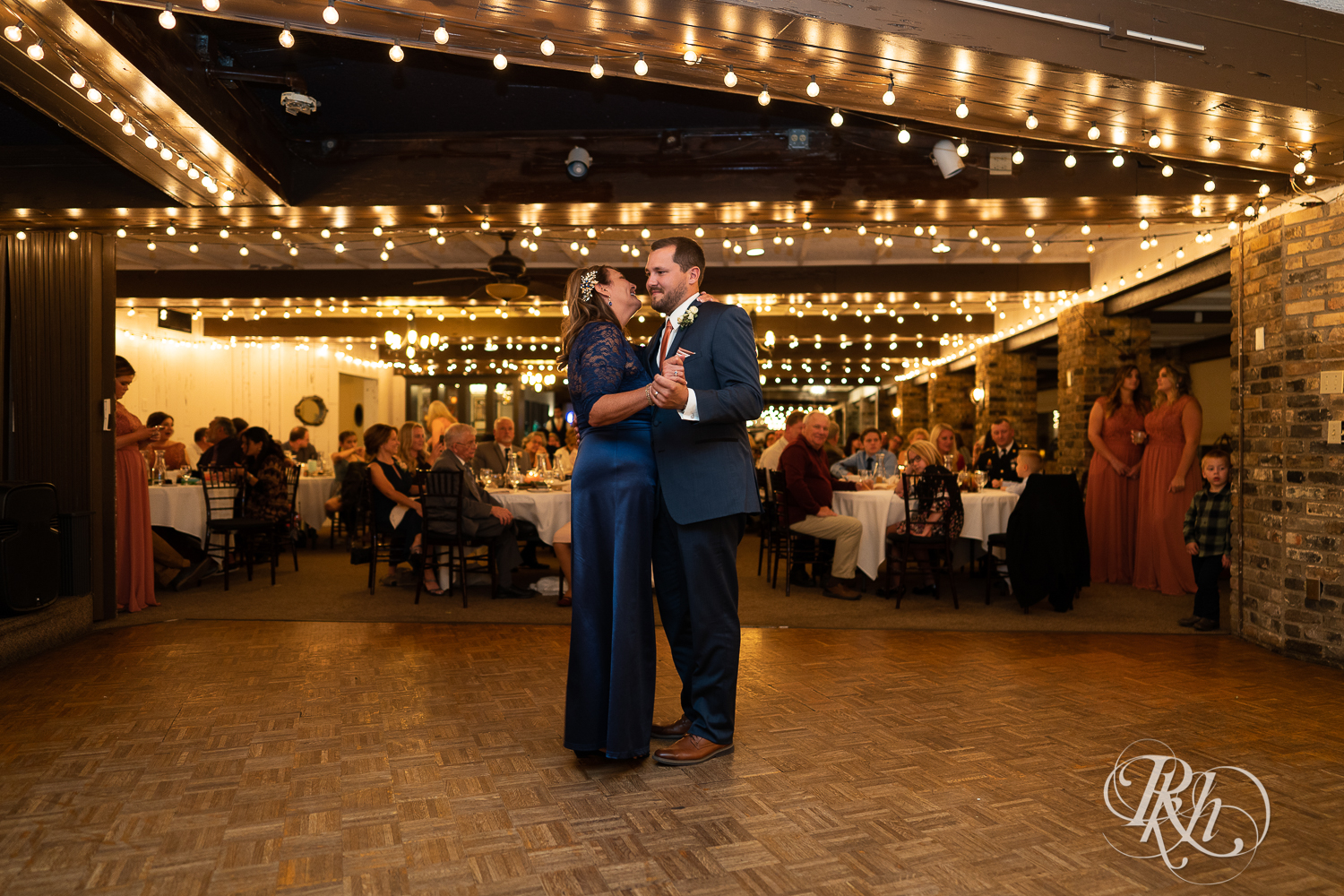 Mother and groom dance during wedding reception at The Chart House in Lakeville, Minnesota.