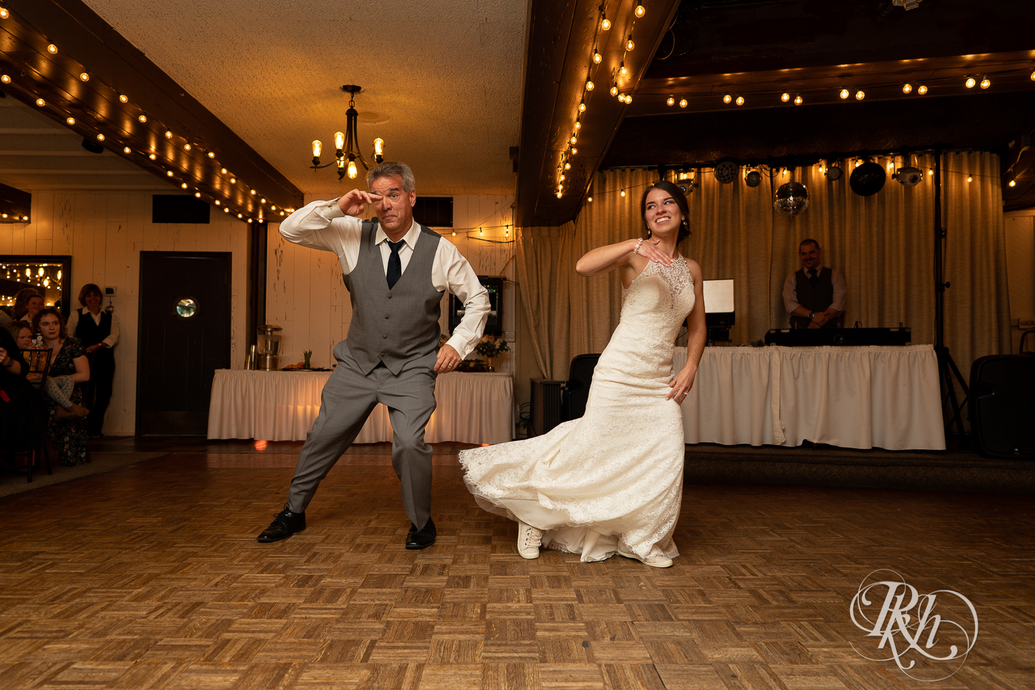 Bride and her dad dance during wedding reception at The Chart House in Lakeville, Minnesota.