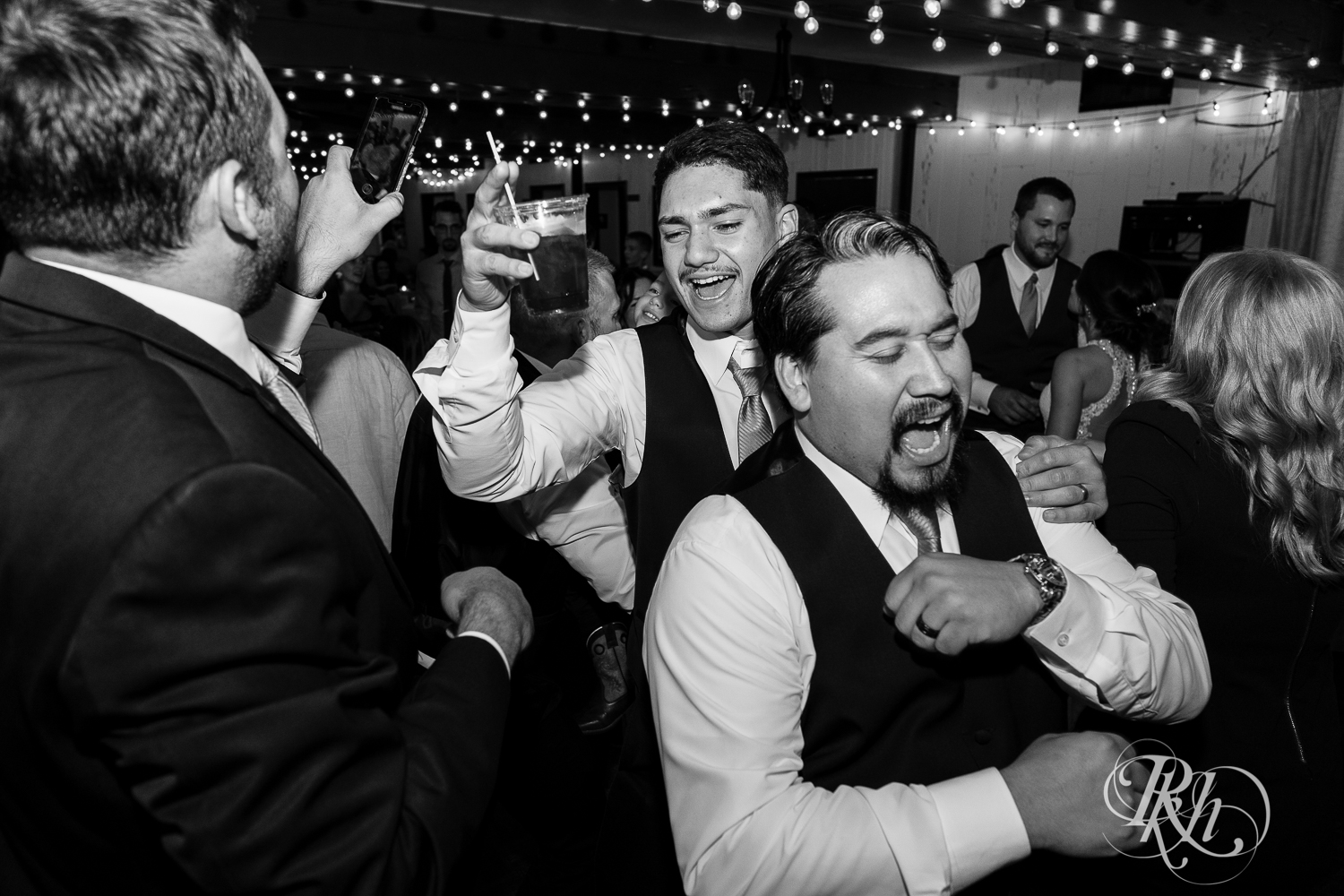 Guests dance during wedding reception at The Chart House in Lakeville, Minnesota.