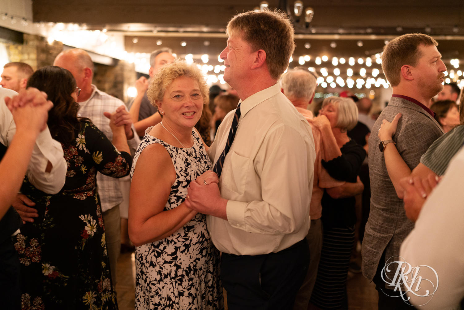 Guests dance during wedding reception at The Chart House in Lakeville, Minnesota.