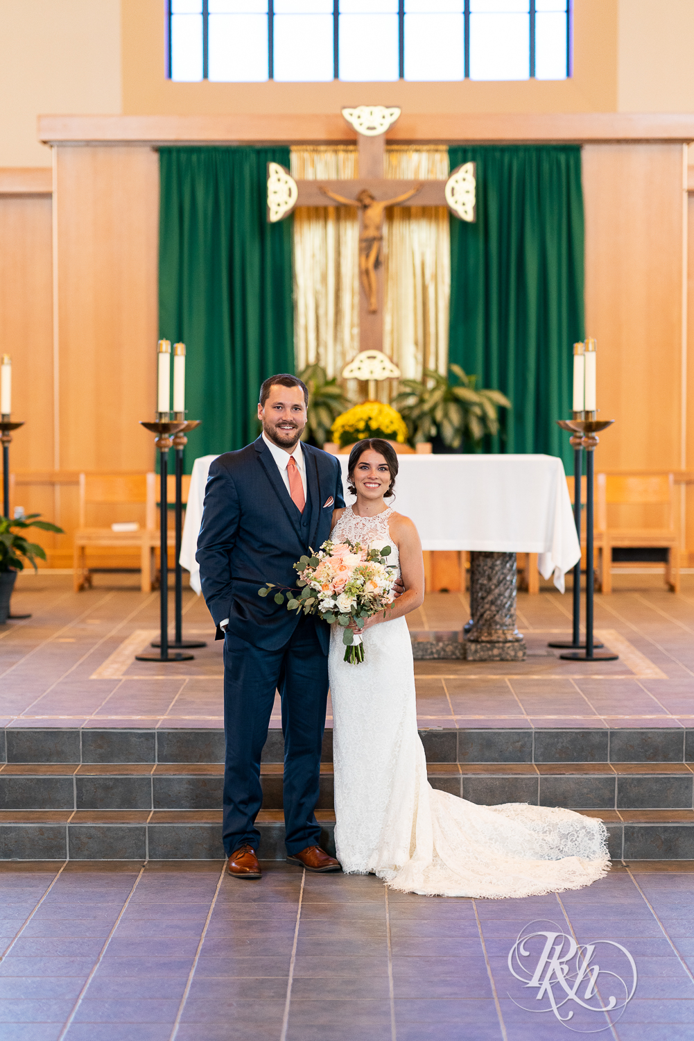 Bride and groom smile at Saint Joseph Catholic Church in Rosemount, Minnesota.