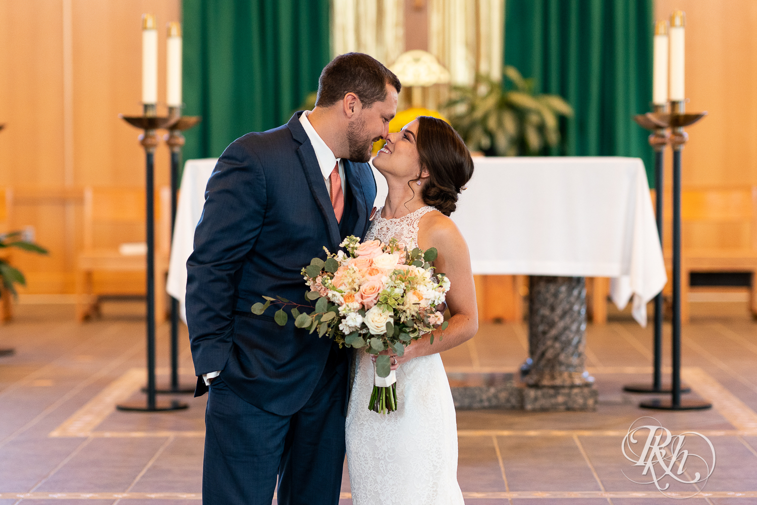 Bride and groom smile at Saint Joseph Catholic Church in Rosemount, Minnesota.