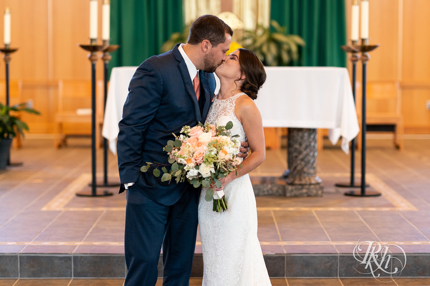Bride and groom kiss at Saint Joseph Catholic Church in Rosemount, Minnesota.