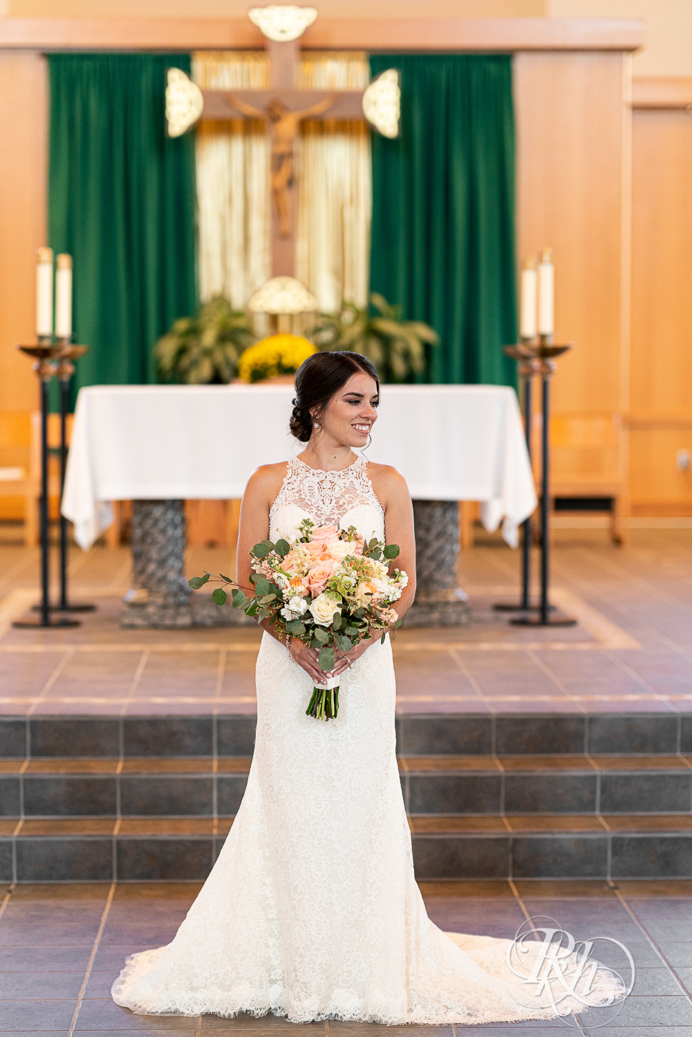 Bride holding flowers and looking to the left at Saint Joseph Catholic Church in Rosemount, Minnesota.