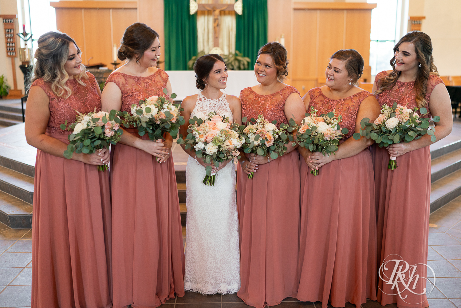 Wedding party in pink dresses at Saint Joseph Catholic Church in Rosemount, Minnesota.