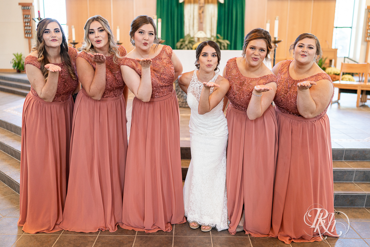 Wedding party in pink dresses at Saint Joseph Catholic Church in Rosemount, Minnesota.