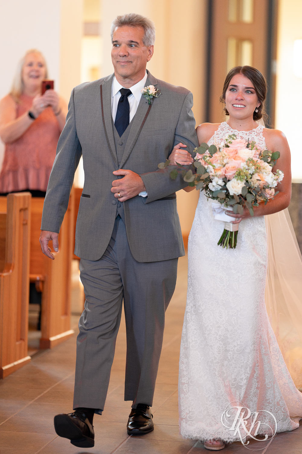 Bride walking down the aisle with father at Saint Joseph Catholic Church in Rosemount, Minnesota.