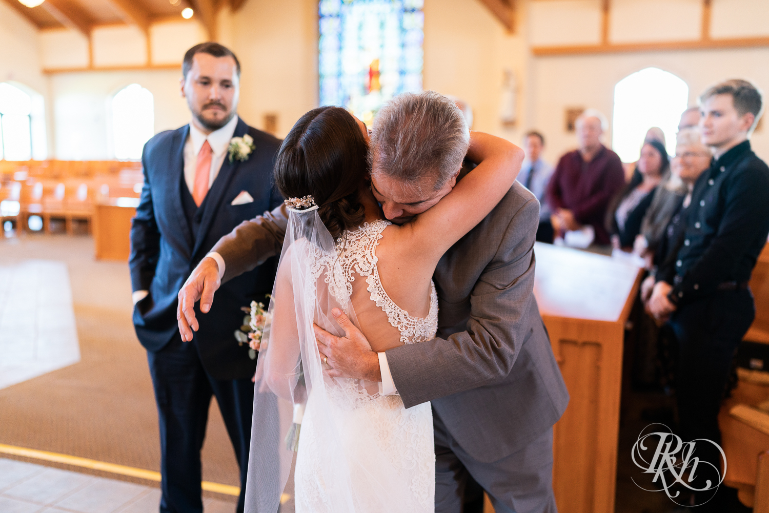 Father hugging bride at Saint Joseph Catholic Church in Rosemount, Minnesota.