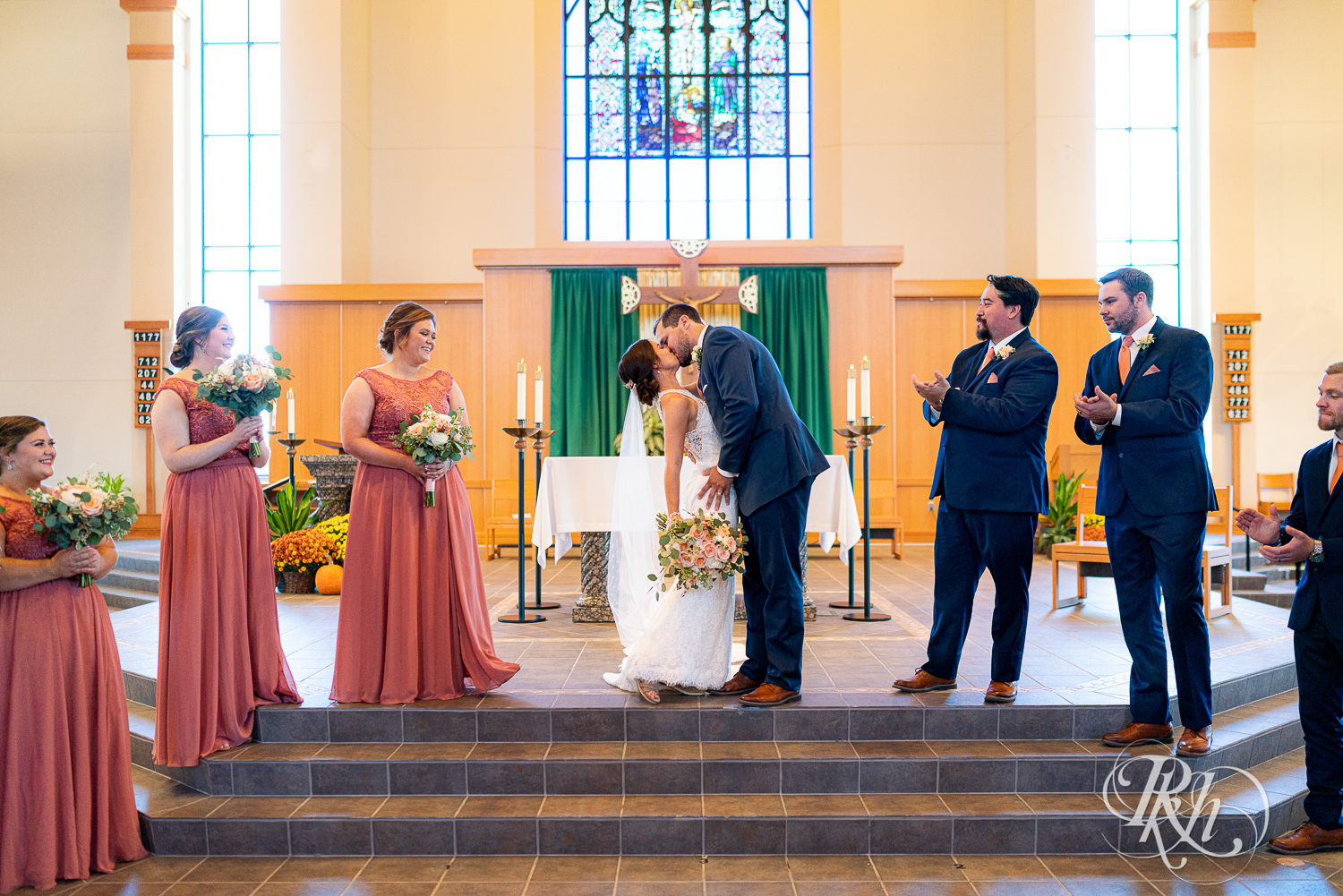 First kiss at Catholic wedding ceremony at Saint Joseph Catholic Church in Rosemount, Minnesota.