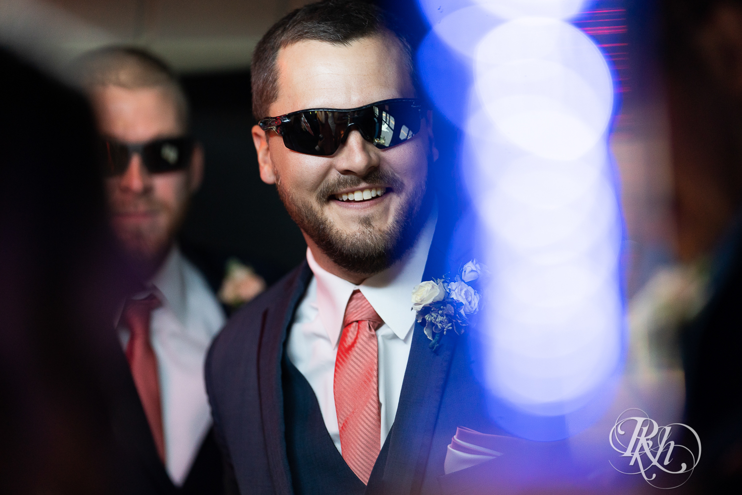 Groom in sunglasses on party bus in Minnesota.