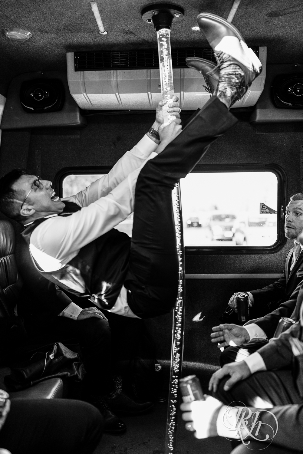 Groomsmen upside down on a pole in a party bus in Minnesota.