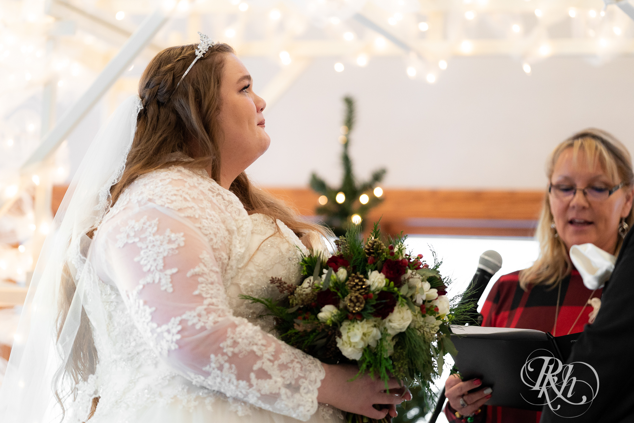 Bride crying at ceremony at Christmas wedding at Oak Glen Golf Course in Stillwater, Minnesota.