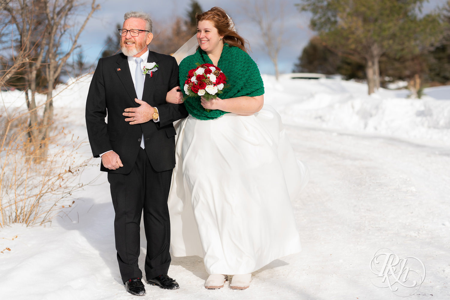 Bride walking down the aisle in the snow at Grand Superior Lodge in Two Harbors, Minnesota.
