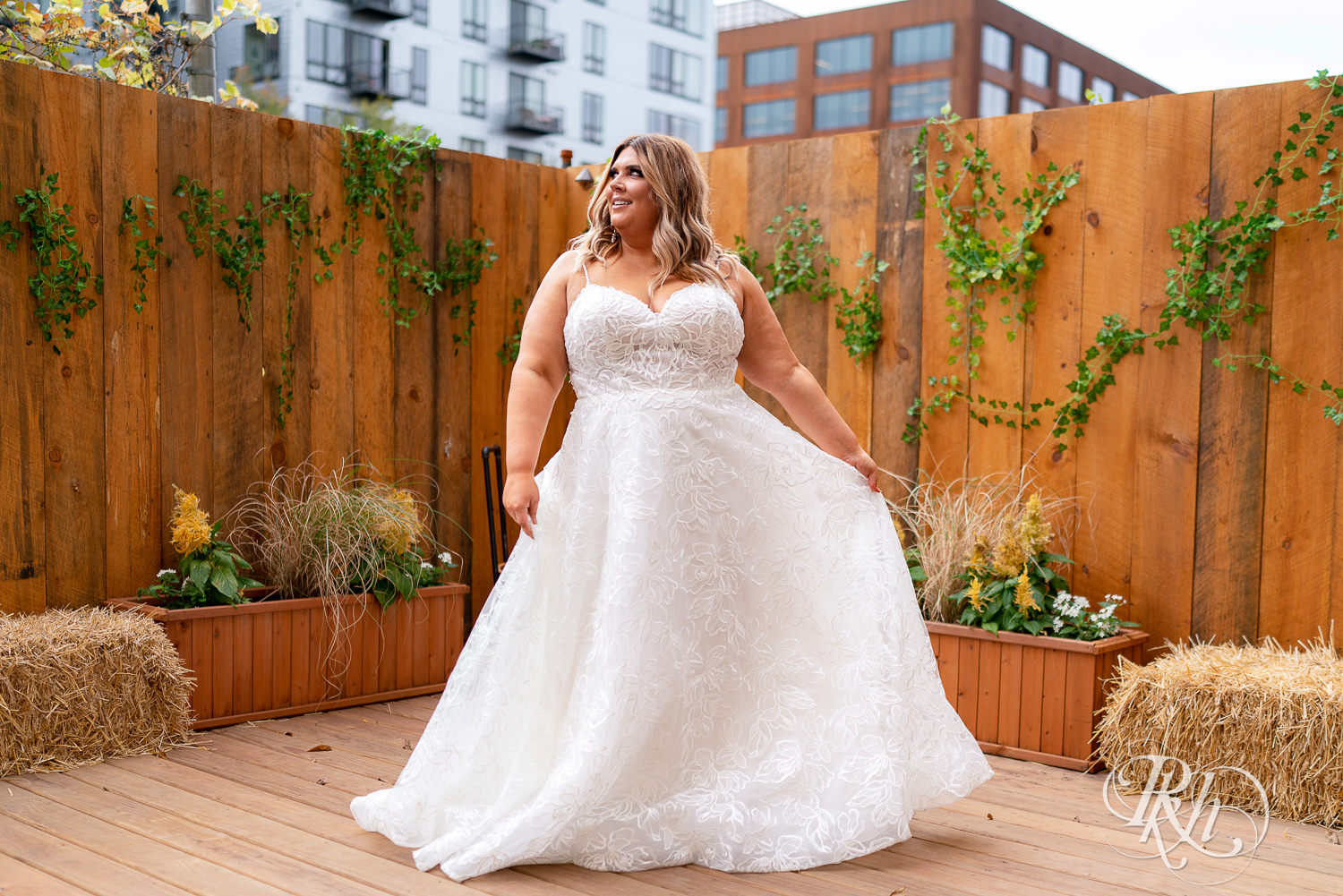 Plus size bride dancing in lacy wedding dress in Minneapolis, Minnesota.